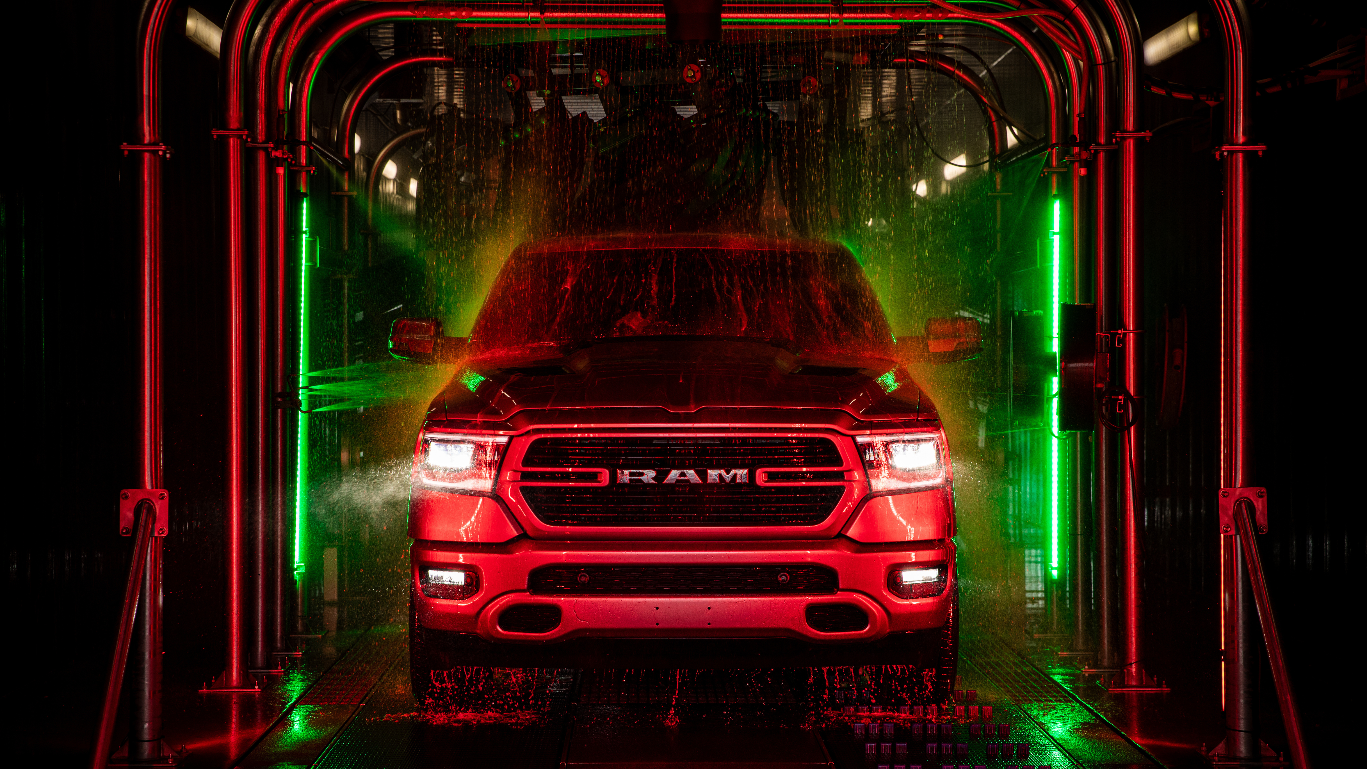 A car inside an express tunnel car wash being rinsed off.